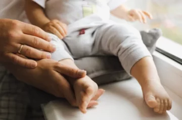 little boy in the arms of his parents